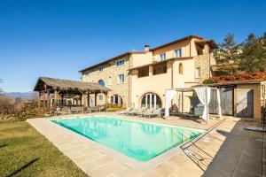 a swimming pool in front of a house at Villa Francesca in Poppi