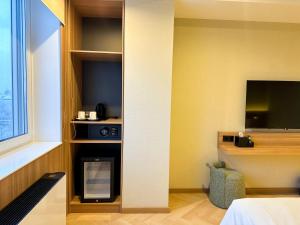 Postel nebo postele na pokoji v ubytování Resident Hotel Abay