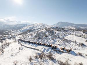 a long line of train cars on a snowy mountain at GO Villas - Brezovicë in Brezovica