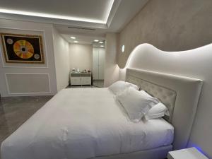 a bedroom with a large white bed with white pillows at B&B HYPNOS - Luxury Suite Pescara in Pescara