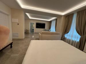 a bedroom with a bed and a living room at B&B HYPNOS - Luxury Suite Pescara in Pescara +7 photos