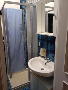 a bathroom with a sink and a shower at Casa Marion in Torre a Mare