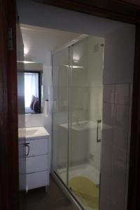 a bathroom with a glass shower with a sink and a tub at Residencial Miguel José in Estremoz +75 photos