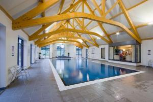 a large swimming pool in a building with wooden beams at 8 berth Caravan in Morecambe