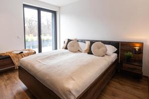 a large bed in a room with a large window at Villa Porta Verde I in Balatonalmádi +42 photos