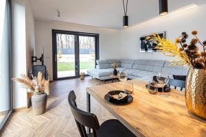 a living room with a table and a couch at Villa Porta Verde I in Balatonalmádi