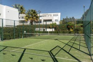 a tennis court in front of a building at Casa Elegante Casares Costa Golf in Casares