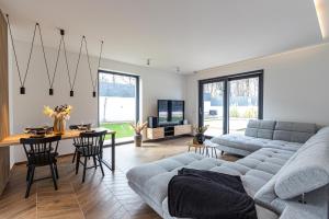 a living room with a couch and a table at Villa Porta Verde I in Balatonalmádi