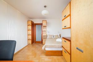 a small bedroom with two beds and a desk at Tarchomin Standard Apartment in Warsaw