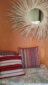 a bedroom with two pillows and a mirror on the wall at Sea way in Kizimkazi +8 photos