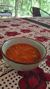 a bowl of soup sitting on top of a table at Sea way in Kizimkazi