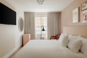 a hotel room with a large bed and a window at FOUND Hotel Miami Beach in Miami Beach +64 photos
