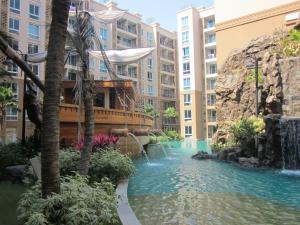 a pool in the middle of a building with a waterfall at Atlantis Condo Resort by Anatolii in Jomtien Beach