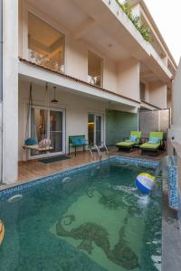 a house with a swimming pool in the backyard at Alaya Stays Cavalo Marinho - 3 BHK Boho Retreat with Private Pool & Terrace in Camorlim