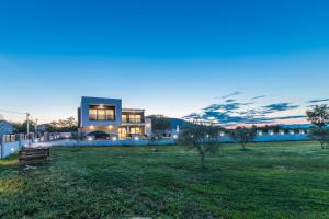 a large house in a field at night at Villa F&A ZadarVillas in Donje Raštane