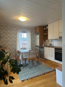 a kitchen with a table and chairs and a window at Brändö Bike and Bed in Brändö