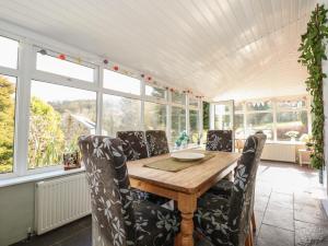a dining room with a wooden table and chairs at Melin Rhos Farm in Penrhos-Lligwy