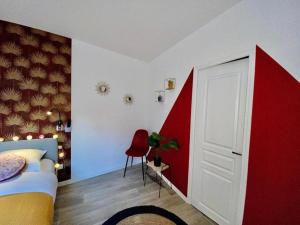 a bedroom with a bed and a red and white door at Le Big Road Rouge in Roubaix