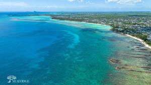 an aerial view of the ocean and a beach at Kanope Bay - Holiday Beachfront Apartments in Pointe aux Biches