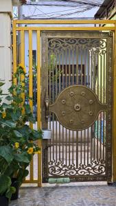 a metal gate with a clock on it at Dan Family Homestay in Ấp Bình Hưng