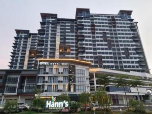 a large apartment building with a sign on it at Hann's Residence - Anna 温馨公寓式的住宅 in Sibu