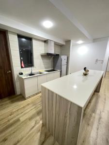 a kitchen with a white counter top in a room at Hann's Residence - Anna 温馨公寓式的住宅 in Sibu