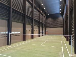 a tennis court with a net in a gym at Hann's Residence - Anna 温馨公寓式的住宅 in Sibu