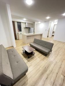 a living room with two couches and a table at Hann's Residence - Anna 温馨公寓式的住宅 in Sibu