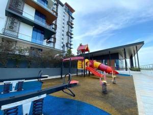 a playground in front of a building with a slide at Hann's Residence - Anna 温馨公寓式的住宅 in Sibu