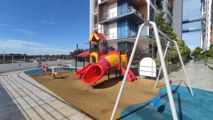 a playground in front of a building at Hann's Residence - Anna 温馨公寓式的住宅 in Sibu