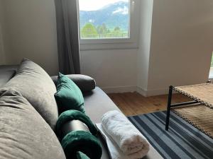 a couch with green pillows in a living room at Maison calme in Seyne +5 photos