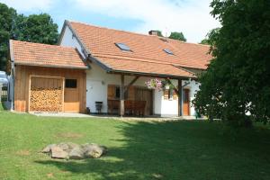 a white house with a red roof and a yard at Ferienhaus Winter in Blaibach