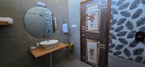 a bathroom with a sink and a mirror at The Pluck Homestay- Umagarh in Rāmgarh