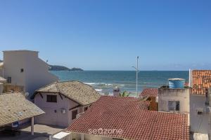 a view of the ocean from the roofs of buildings at Apto Vista Mar 3Q e Garagem 130m da Praia ROR0002 in Bombas