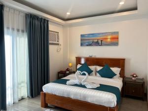 Postel nebo postele na pokoji v ubytování Ocean Star Hotel Coron