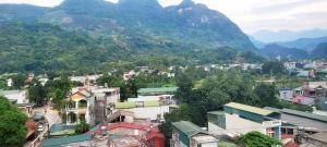 a view of a city with mountains in the background at Peaceful Mountain Hotel in Ha Giang