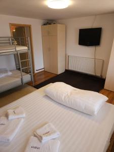 a room with a bed with two white towels on it at Undeva la Mosie in Podu Dîmboviţei