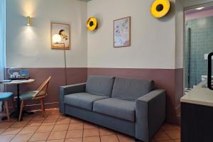 a living room with a couch and a table at Aparthotel AMMI Vieux Nice in Nice