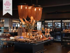 a restaurant with a buffet of food and a chandelier at Boho Club in Marbella
