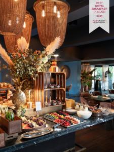 a buffet with many plates of food on a table at Boho Club in Marbella