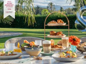 a table with a plate of food on it at Boho Club in Marbella