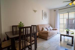 a living room with a couch and a table at CYV - Fun, beach & relax 1 bed 1 bath in Fuengirola