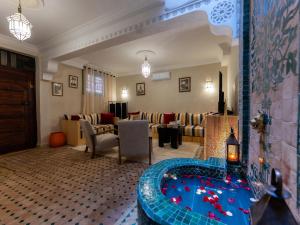 a hotel room with a tub in the middle of a living room at Riad Dar Lamia in Marrakech