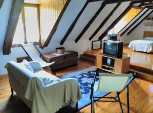 a living room with a couch and a tv at Casa Les in Les