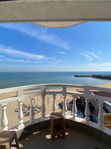 a balcony with a view of the beach and the ocean at Hotel Noy in Varna City