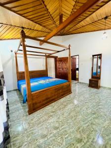 a bedroom with a wooden bed in a room at Gemlita Villa in Uswetakeiyawa in Bopitiya +47 photos
