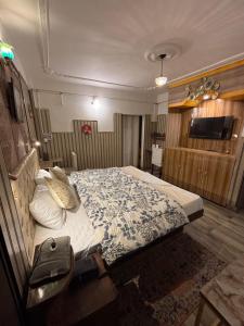 a bedroom with a large bed in a room at Hills Royal Residency in Jālāpahār