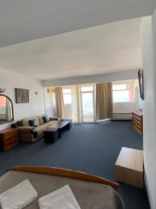 a large living room with a couch and a table at Hotel Noy in Varna City +33 photos