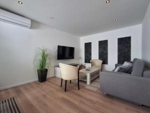 a living room with a couch and a table at Apartmani Alma in Pula