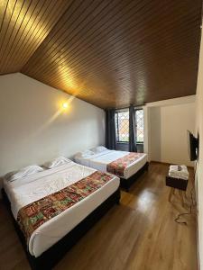 Cama o camas de una habitación en Bamuka Hostal